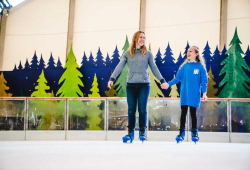 Mum and daughter ice skating